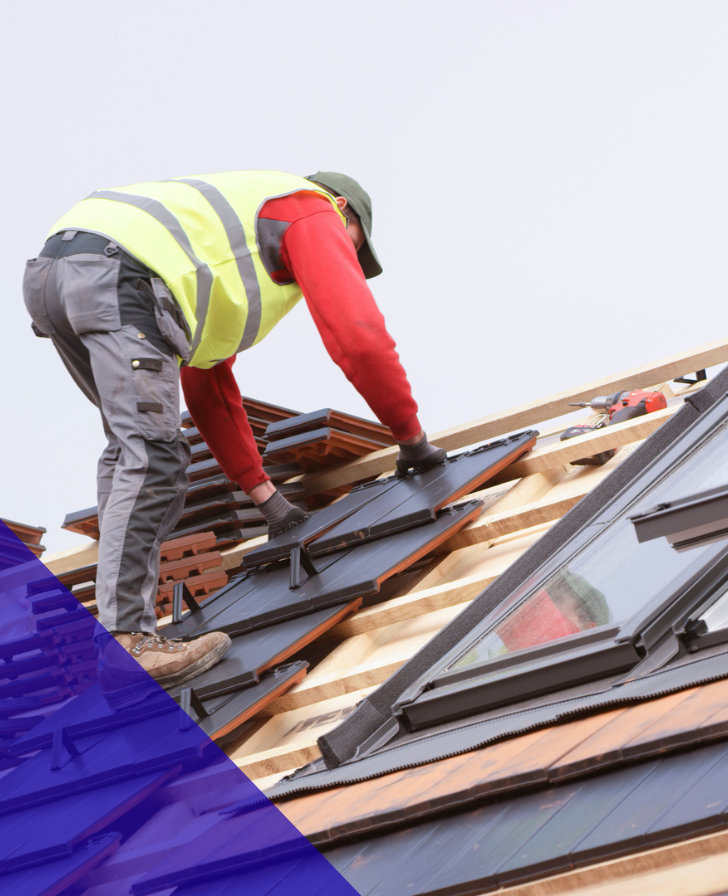 Nuilder in high vis vest on roof